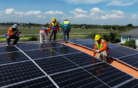 group of people installing solar panels